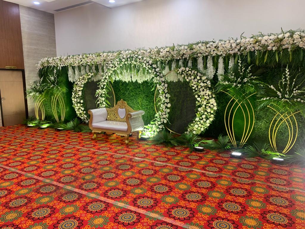 Floral stage decoration with golden couch at KPA Palace